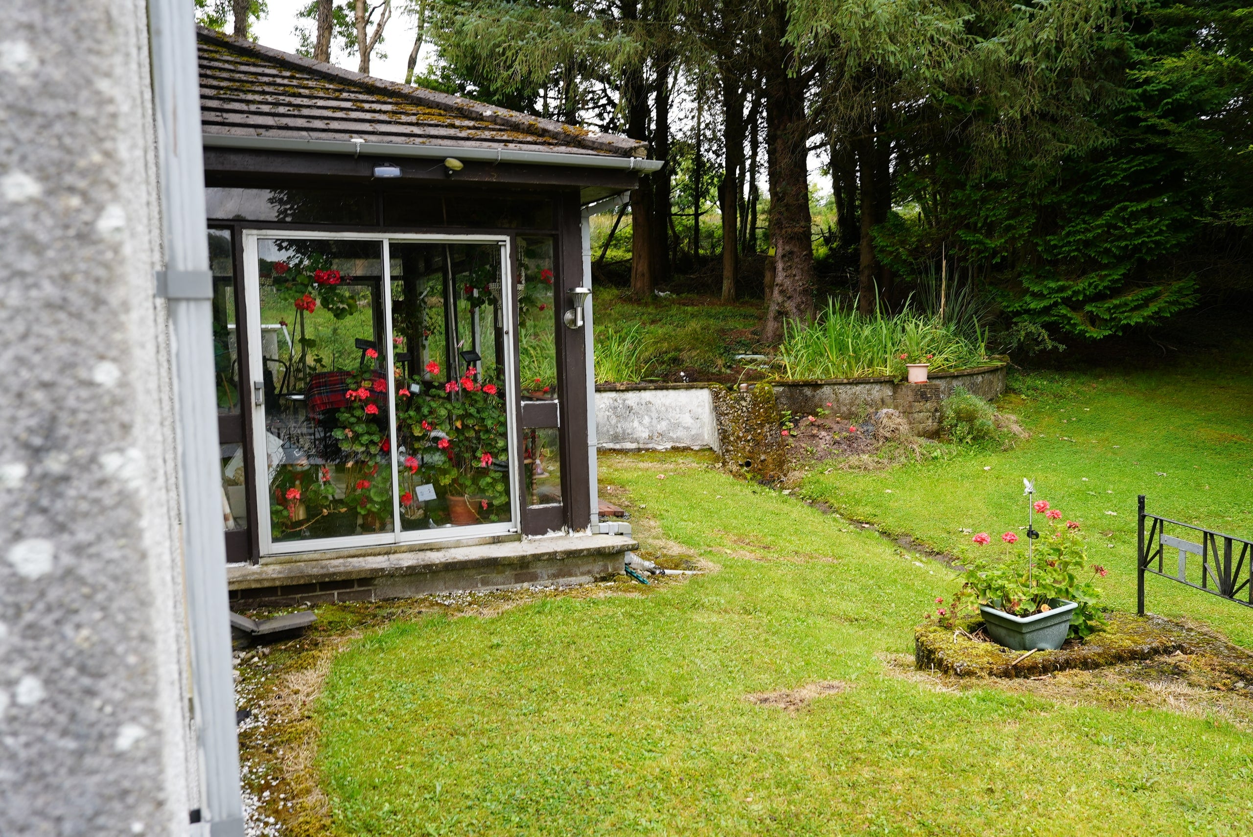 Existing glazed sun porch facing the established grounds
