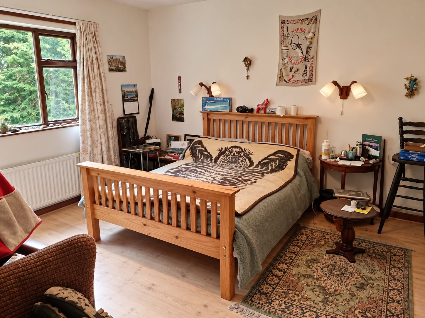 Bedroom with a wooden double bed and a view of the trees