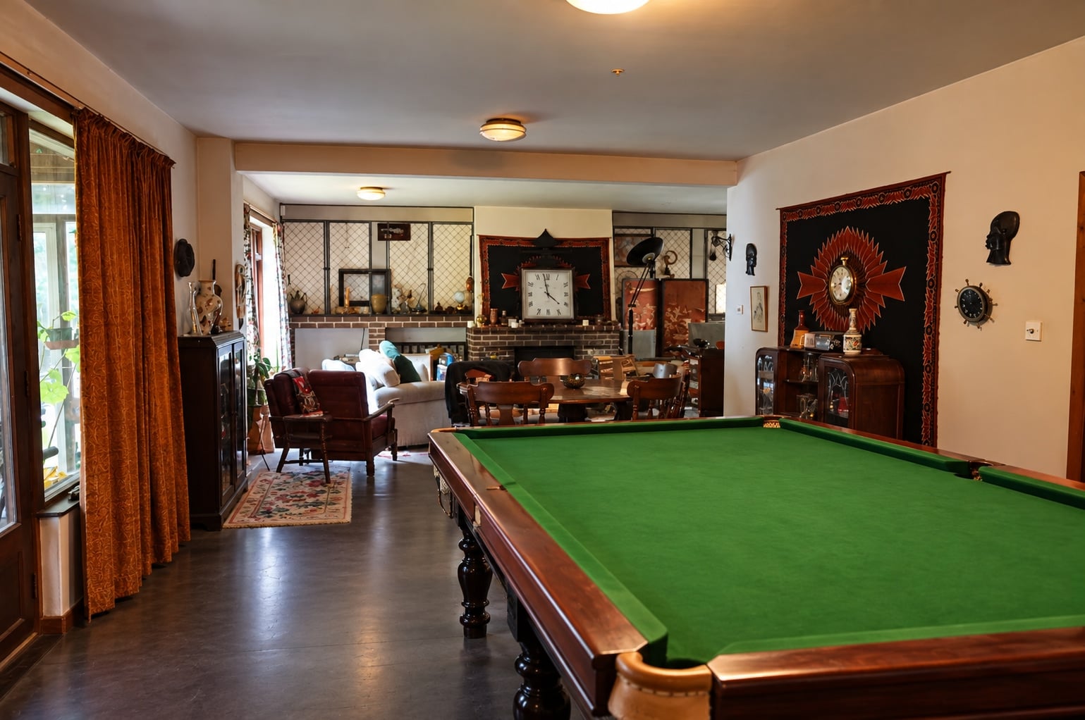 Living and dining room with a pool table and fireplace