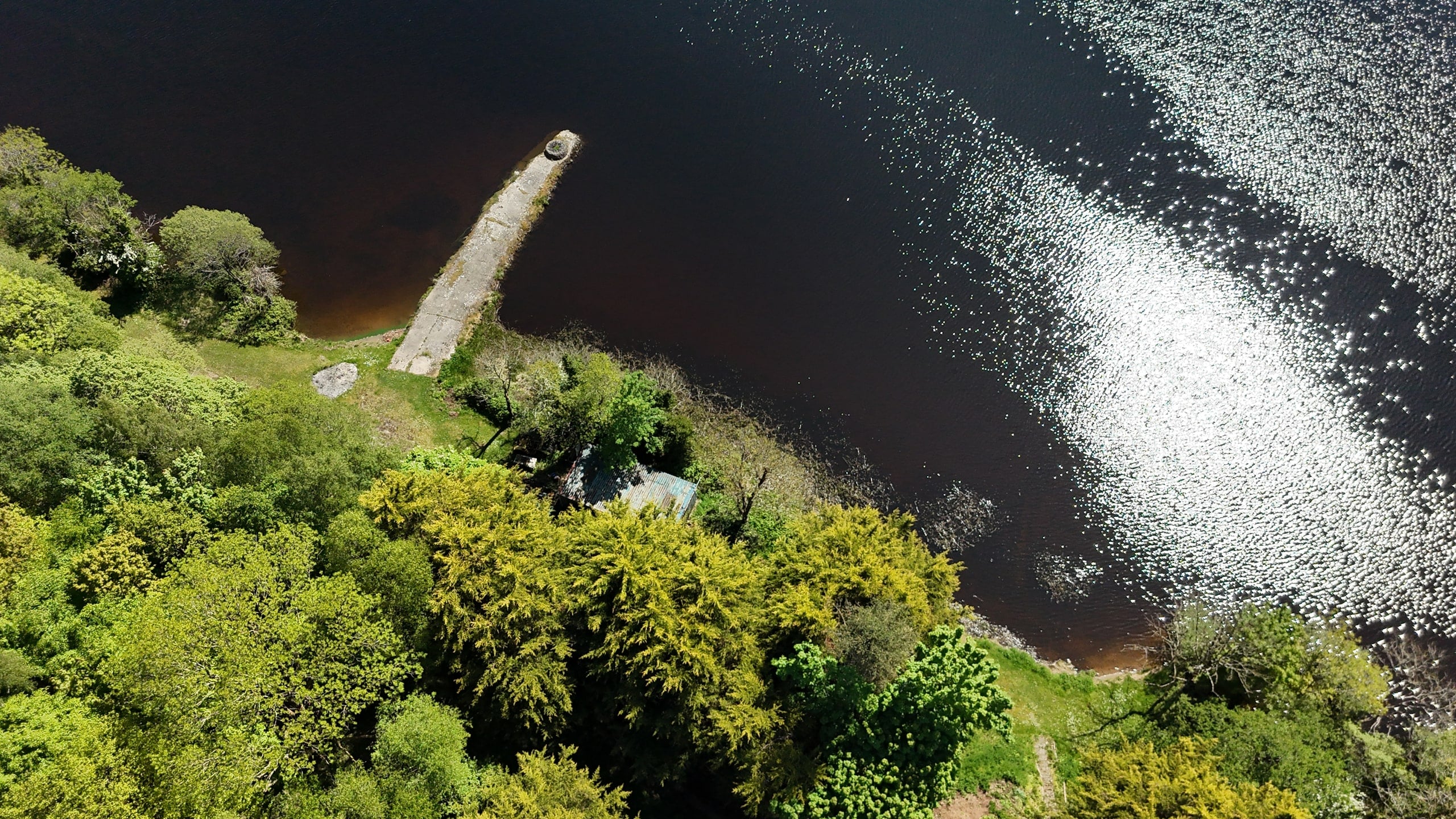 Aerial view of the concrete jetty extending from the shoreline