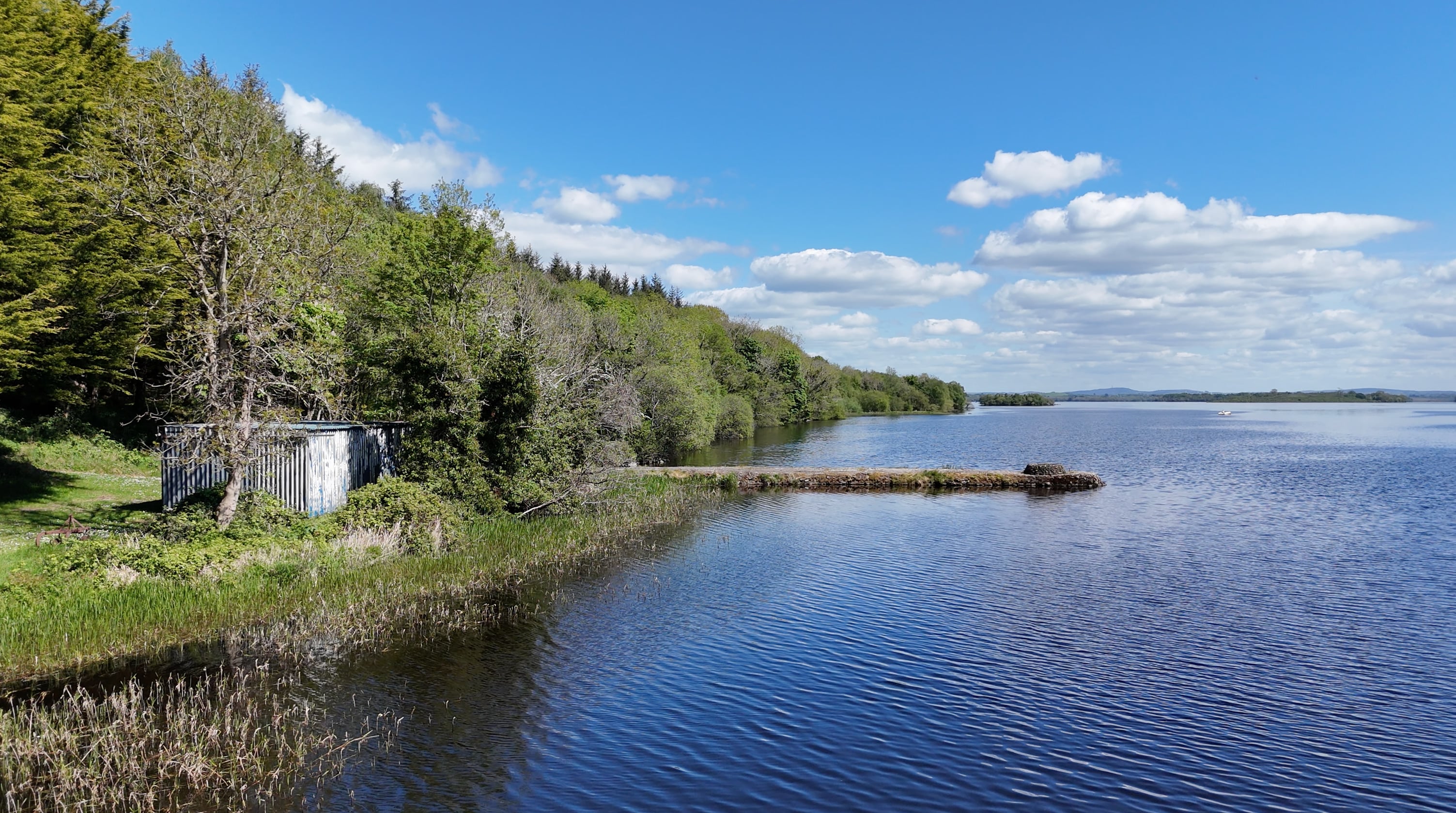 Concrete jetty extending from the shoreline into Lower Lough Erne